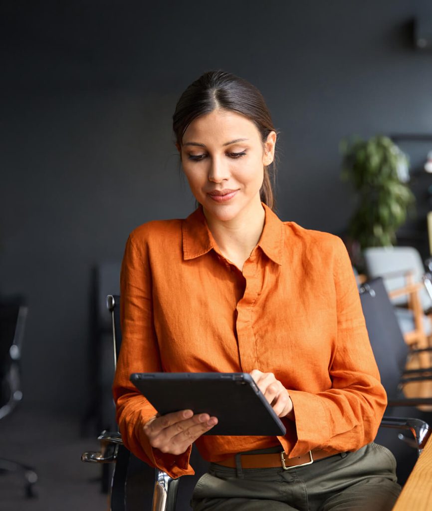 Woman working on a tablet in a modern office